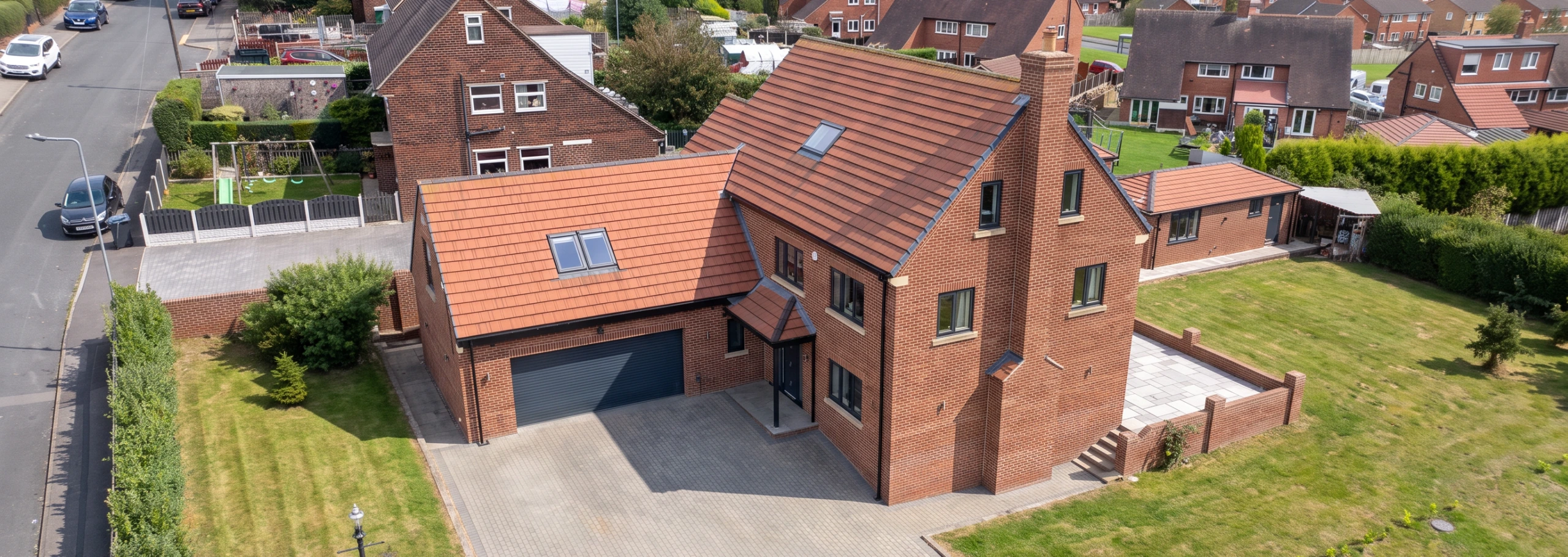Aerial view of a new build six-bedroom detached house with a double garage in Barnsley