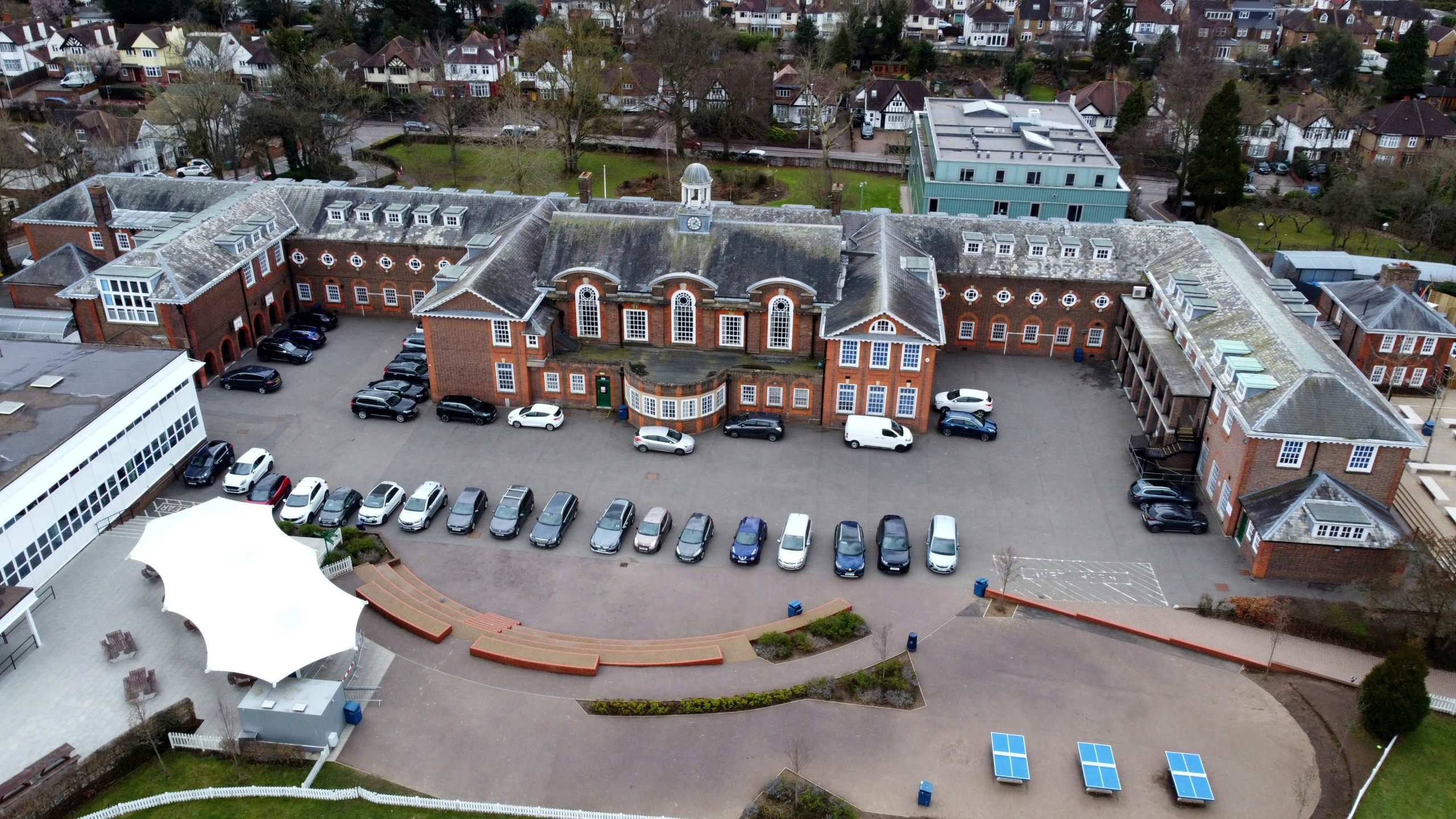 Aerial view of a red brick school campus and its grounds