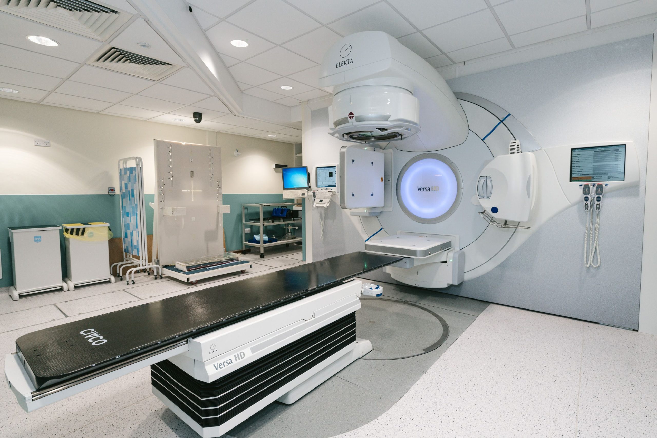Hospital radiotherapy treatment room with a linear accelerator and patient couch