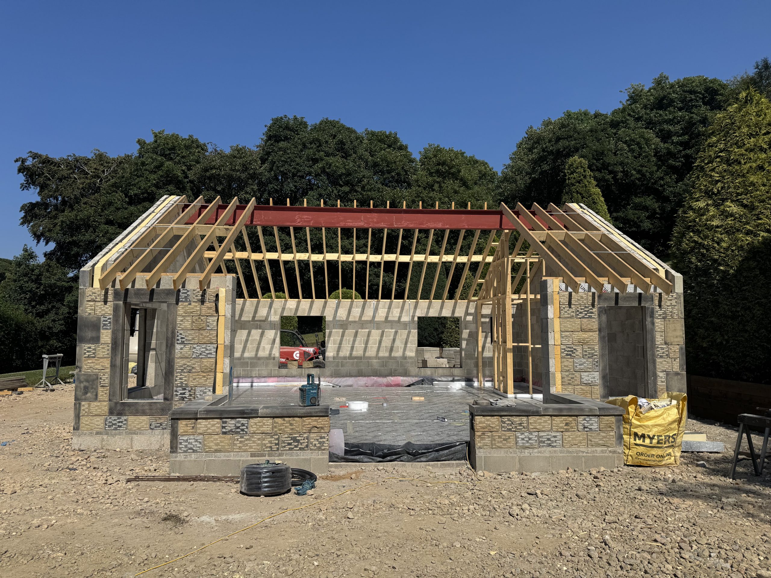 External view of a new garden room with Oak Frame, stone and render walls, timber windows and york stone roof.